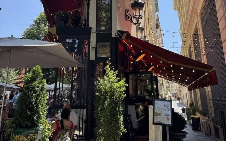 A restaurant frontage with an awning and a menu board on the pavement, where gift vouchers belong alongside everything else people already look at