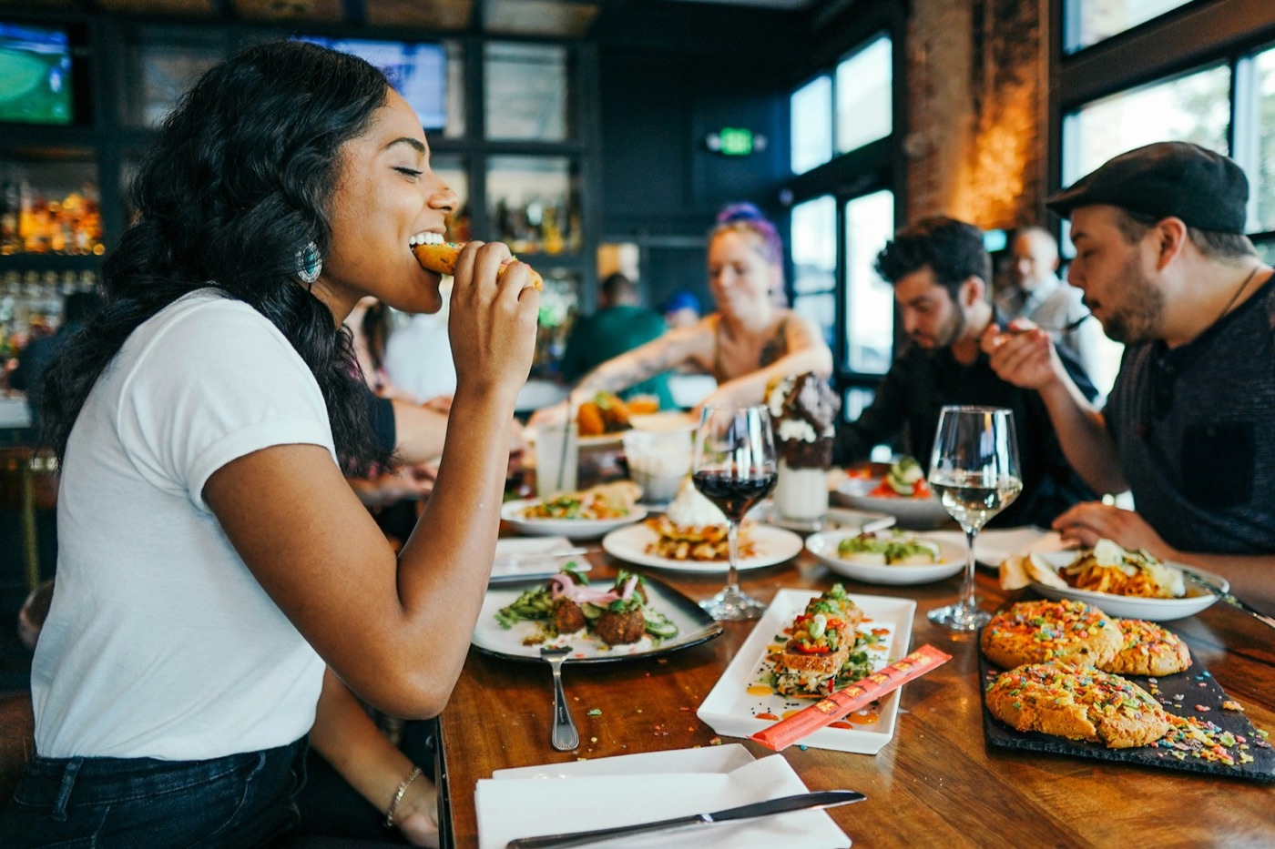 Regular guests enjoying a meal together at a busy restaurant